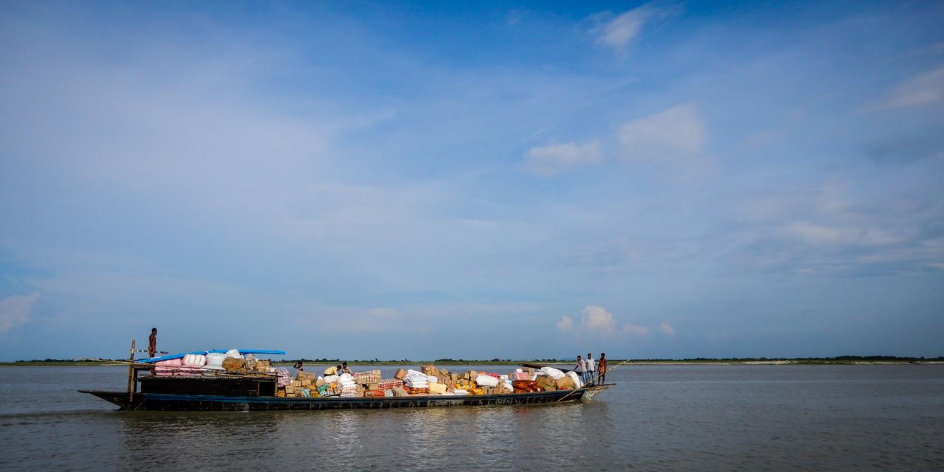 A small mechanized boat carries local trade commodities in Dhubri, Assam. Photo: Sailendra Yashwant/ Oxfam India A small mechanized boat carries local trade commodities in Dhubri, Assam. Photo: Sailendra Yashwant/ Oxfam India