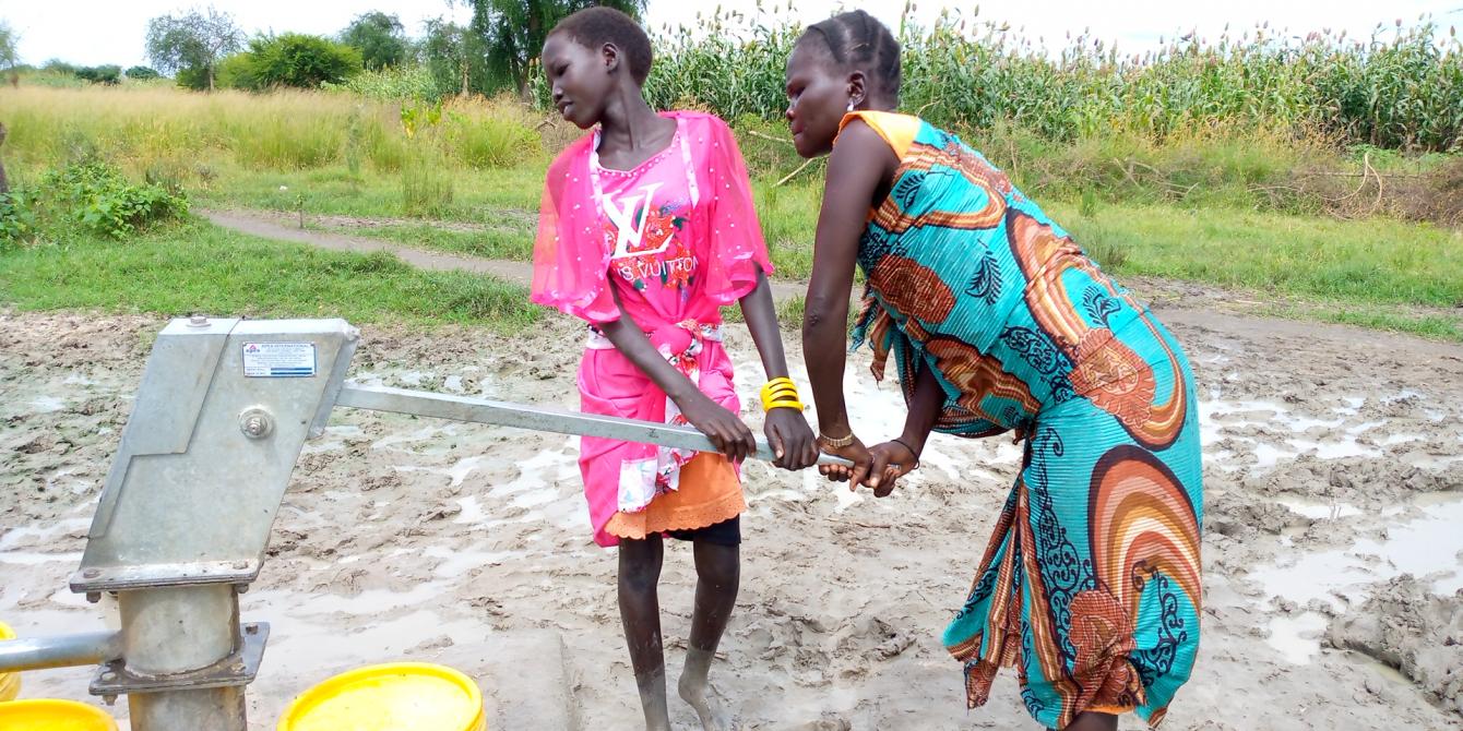 Young school girl helps her mother fetch water  during lock-down in Lankien. Photo by Dominic Kango