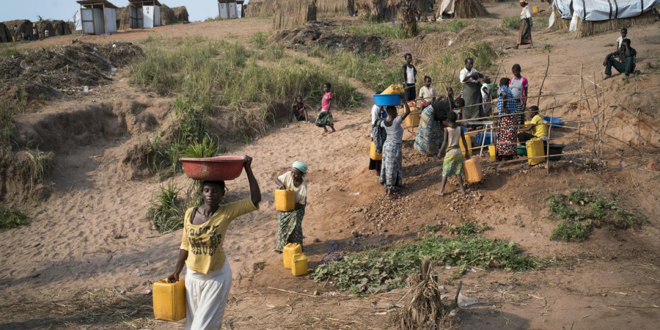 Women collecting water from a tap stand in Kalunga in DRC. Photo by Diana Zeyneb Alhindawi/Oxfam