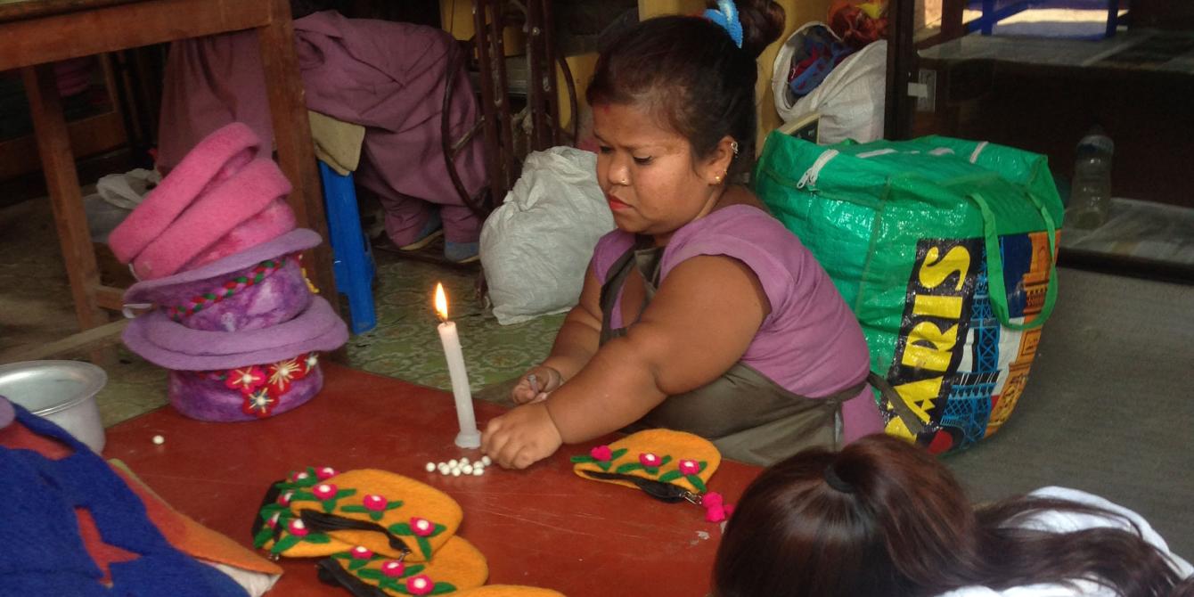 A differently-able woman in Kathmandu making bags from felt A differently-able woman in Kathmandu making bags from felt