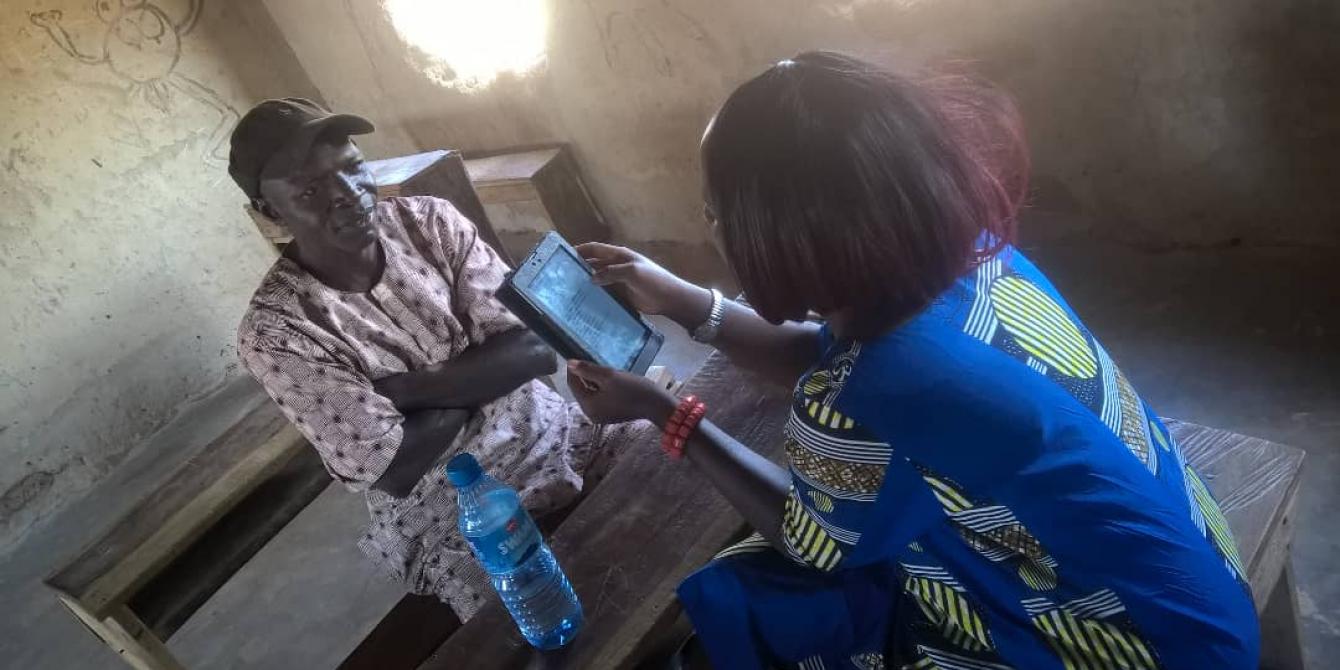 Enumerator interviewing a Household member during a VSLA Baseline Survey Enumerator interviewing a Household member during a VSLA Baseline Survey