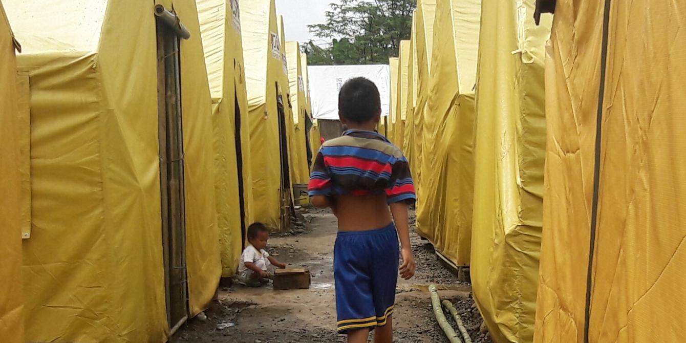 Ahmed walks in a tent city Ahmed walks in a tent city