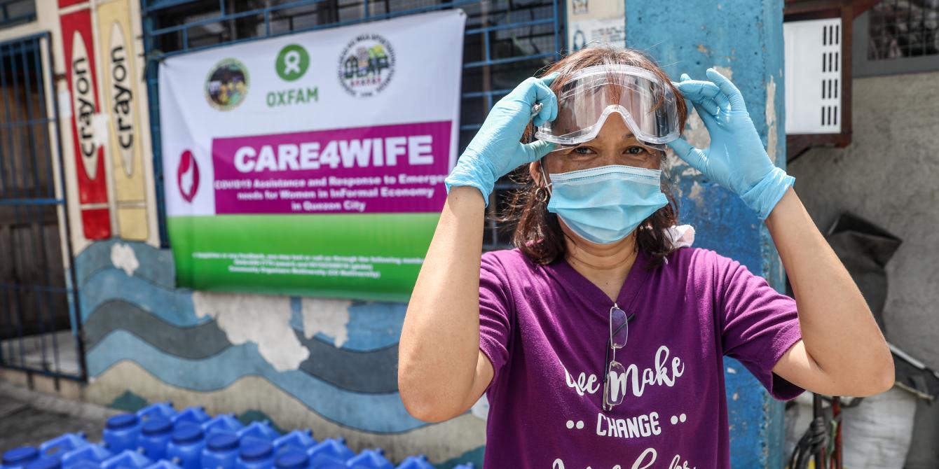 Elizabeth Asanion, 45, wears her protective goggles during a relief operation in partnership with Oxfam Philippines titled Care4Wife: COVID-19 Assistance and Response to Emergency Needs for Women in Informal Economy in Namapa Compound, Barangay North Fairview in Quezon City, Metro Manila, Philippines. PHOTO: Basilio Sepe/Oxfam