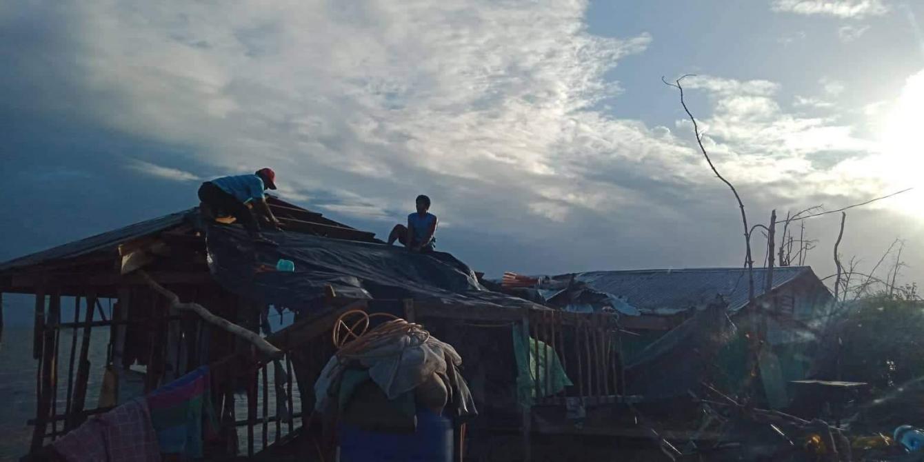 Fisherfolk from Palanas village in Salcedo, Eastern Samar, attempt to repair their damaged homes with tarpaulins a day after Christmas. Typhon Ursula first made landfall in Salcedo on December 24.  Photo credit: Charita Llanera/PDRRN