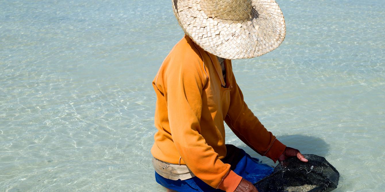 Marie Clar Labtik (50) collects shells to make jewellery, five months after Typhoon Haiyan in Pooc, Bantayan  “We are poor. Because of the typhoon, we can’t rely on our husband’s work. We must work together. Women should be good models to their children and the community.”  Women like Marie Clair are among the many fisherfolk of Bantayan who rely on the sea for their survival, and who remain at risk to extreme weather events like Typhoon Haiyan.Photo: Tessa Bunney/ Oxfam