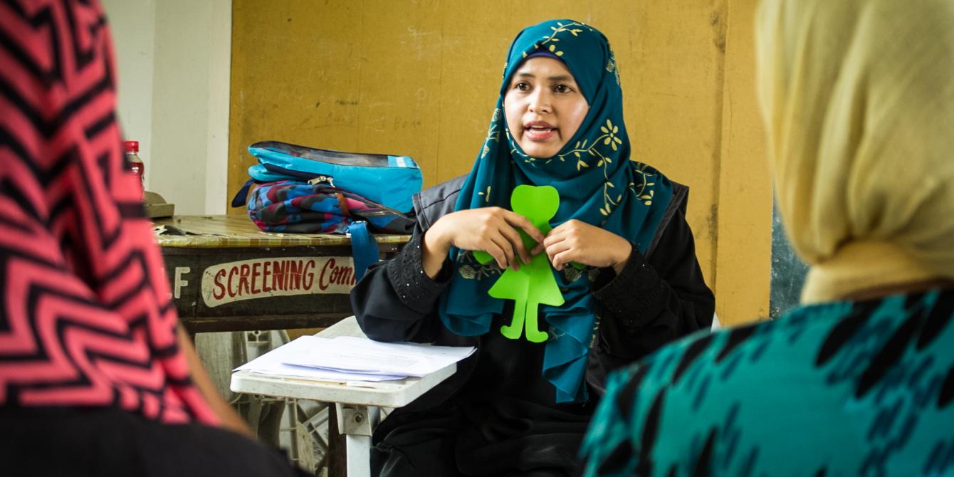 In 2017, Al Mujaadila Women's Association (AMWA) organized Family Conversations, or listening sessions involving fathers, mothers, youth, and children who were displaced during the Marawi crisis. At least 240 families were engaged in these Family Conversations, which helped shape the development of a “People’s Agenda” for the recovery and rehabilitation of Marawi. Here, a community facilitator conducts a debriefing session with women in an evacuation center. (Photo: Genevive Estacaan/Oxfam)