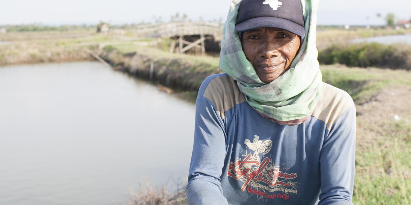 An Indonesian small-scale shrimp farmer and part of his morning harvest. One of the many farmers working alongside PT. ATINA and ASIC to create improvements in shrimp production. - Lanrisang Village, Pinrang Regency, Indonesia. (Photo by C.J. Scott)