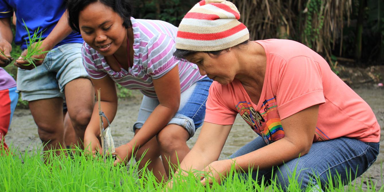 Charito, 34 years old, from Barangay Bagumbayan in Sultan Kudarat tries for the first time   precision seeding taught at the organic farming demonstration farm.(Photo: Genevive Estacaan/Oxfam)