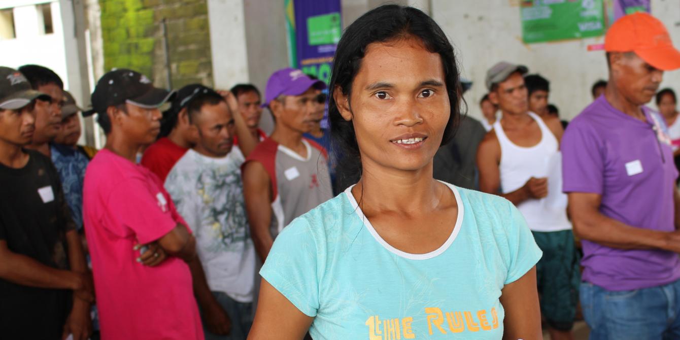 A woman fisherfolk receives her Electronic Prepaid Solution (EPS) Card during a distribution in Tacloban City (Photo: Christian Poleno/Oxfam)