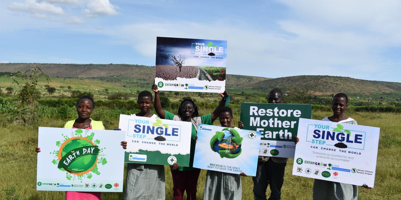A group photo of Oxfam staff and partners on World Earth Day in Isingiro district